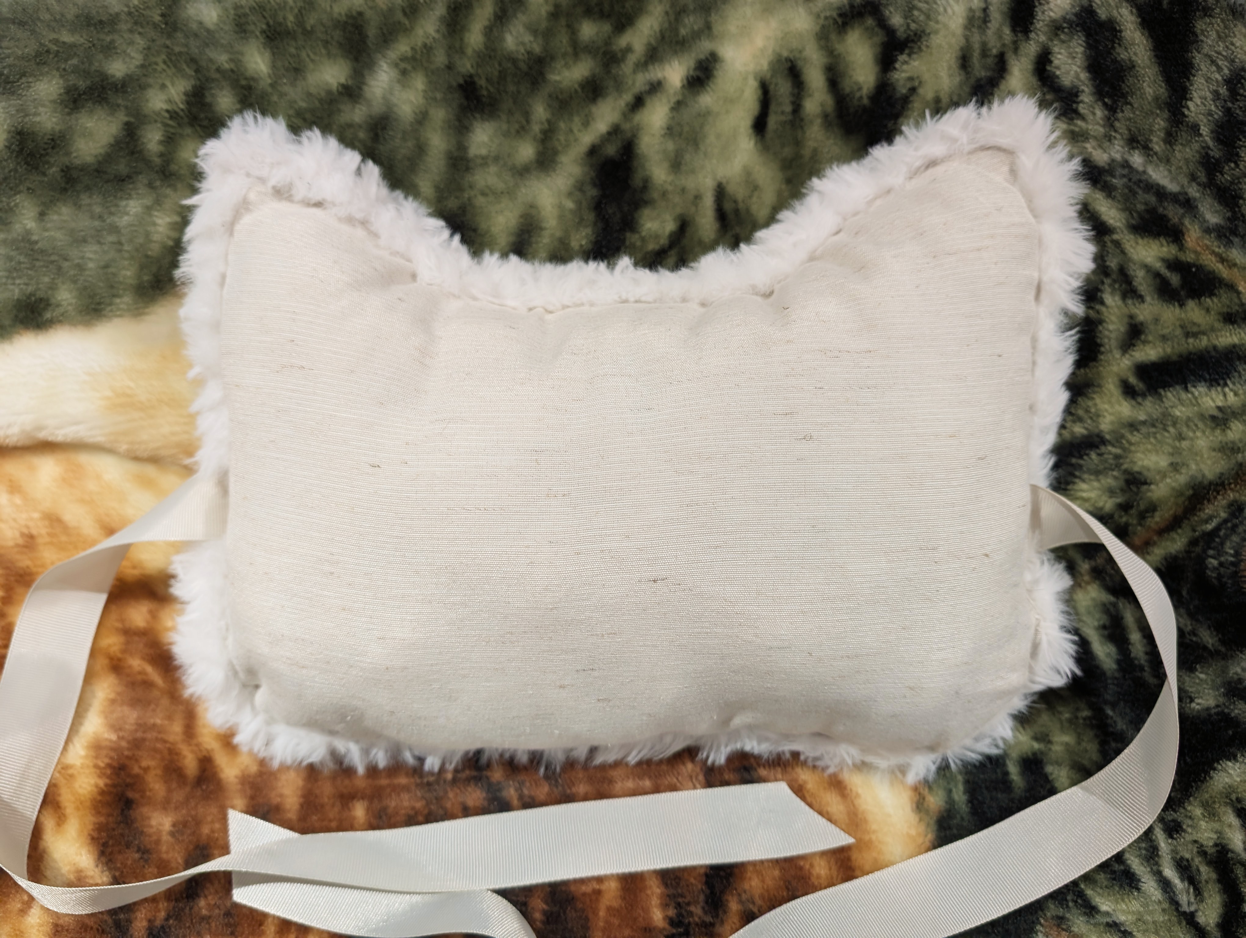 The back of the pillow with fluffy fabric visible around the edges.