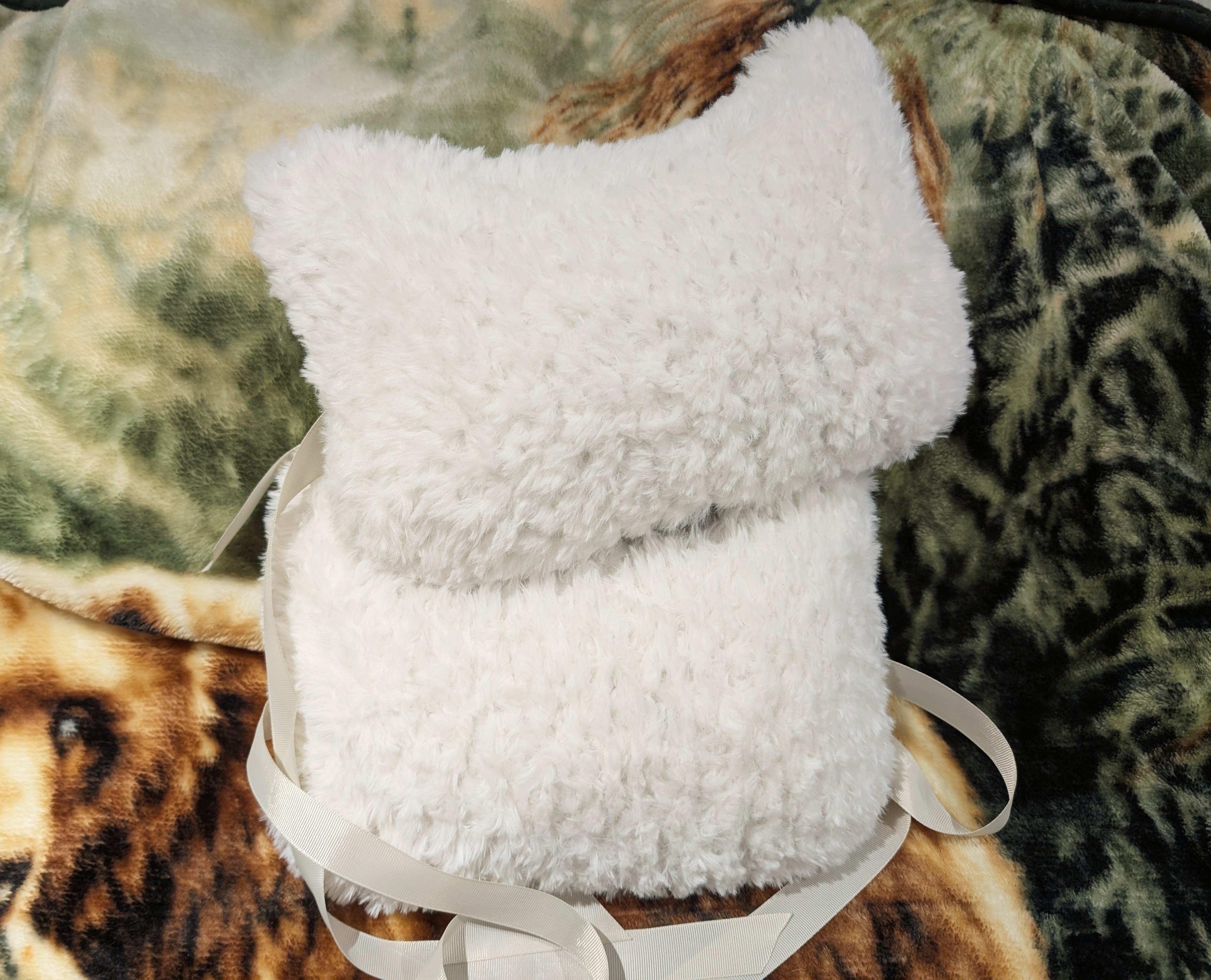 The two finished fluffy pillows with ears.