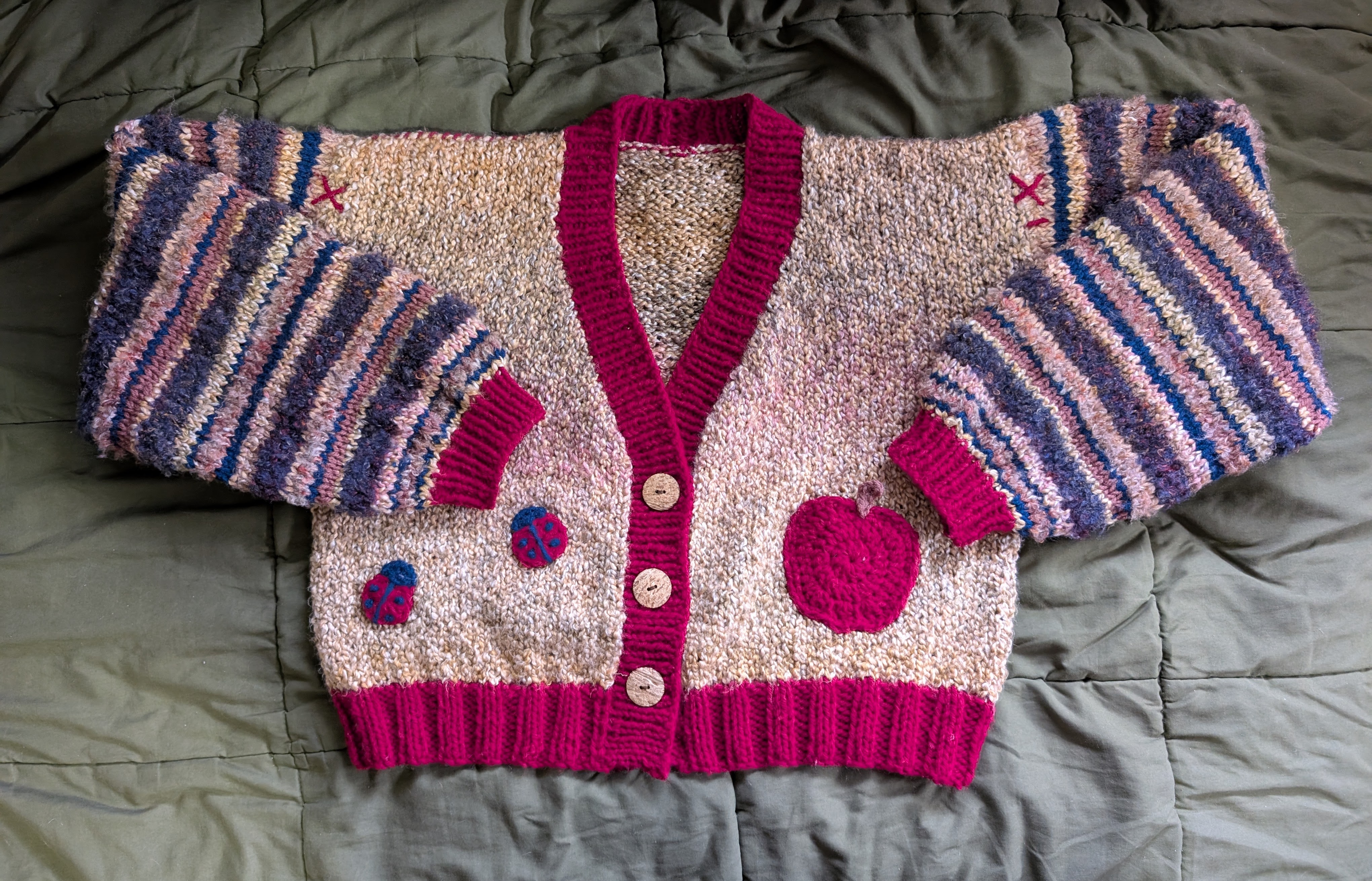 A flatlay of the whimsical cardigan