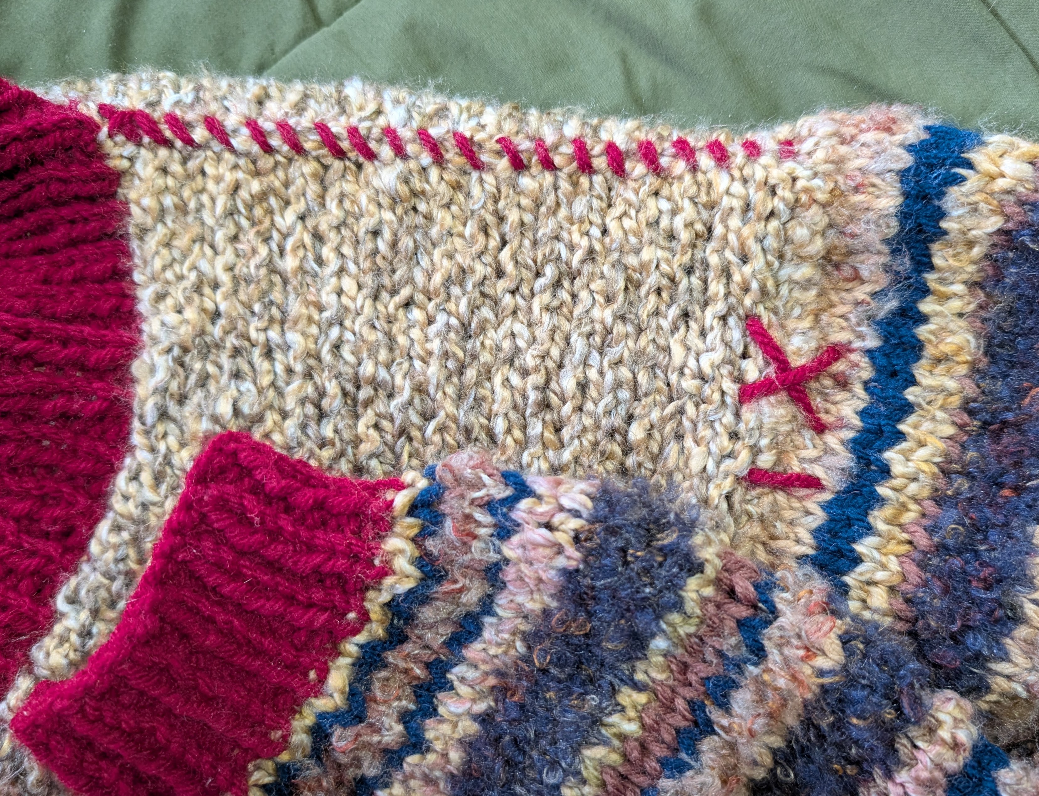 Red yarn stitching along the shoulders